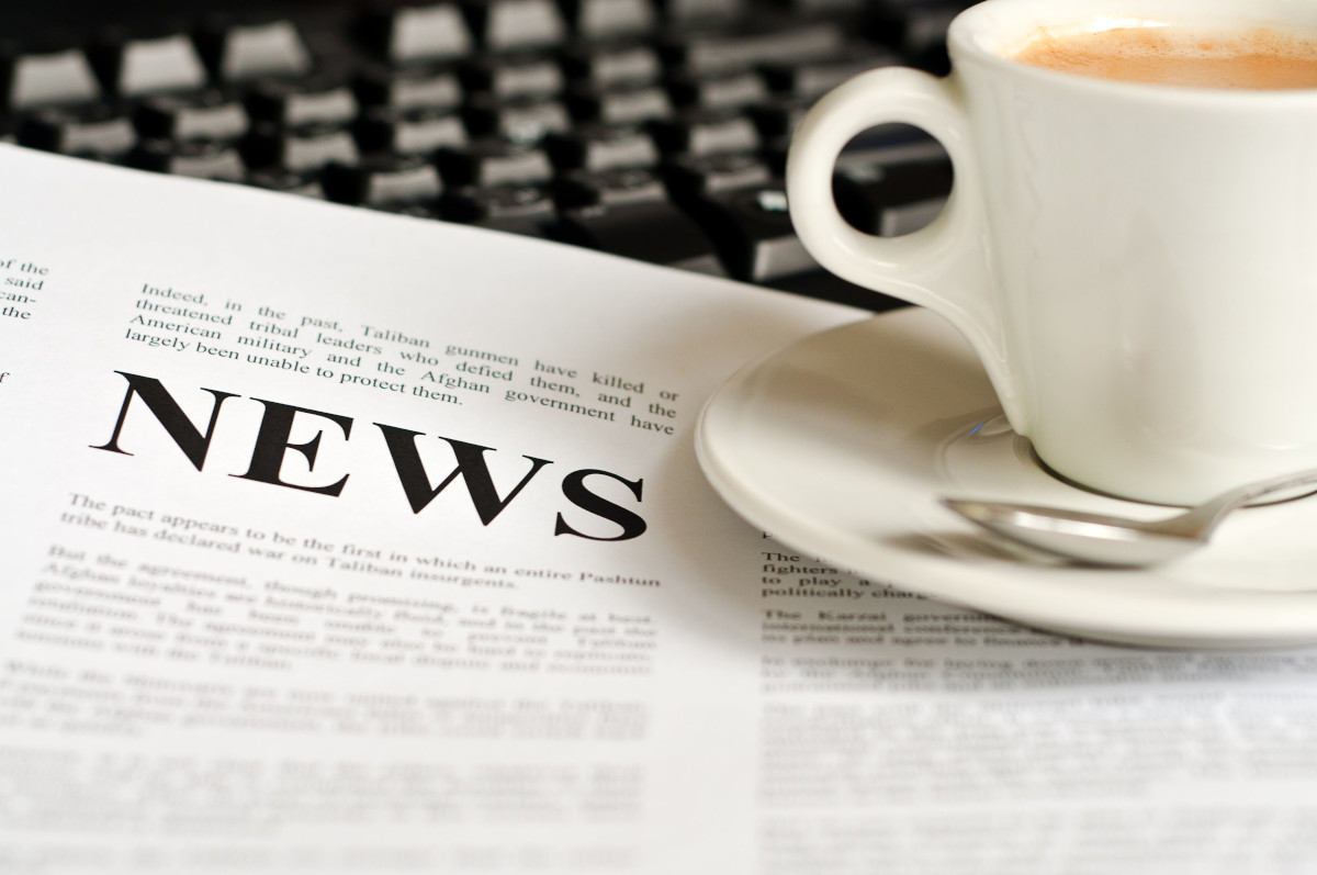 News article and cup of coffee